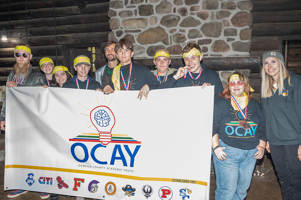  APW students hold the OCAY banner after the competition