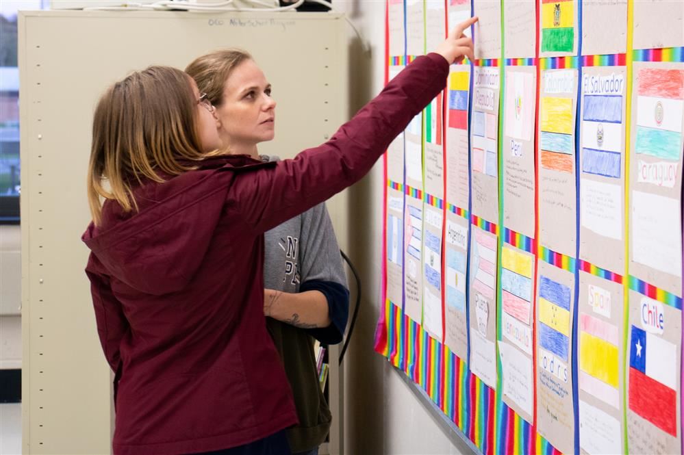  A student shows off her work to a parent