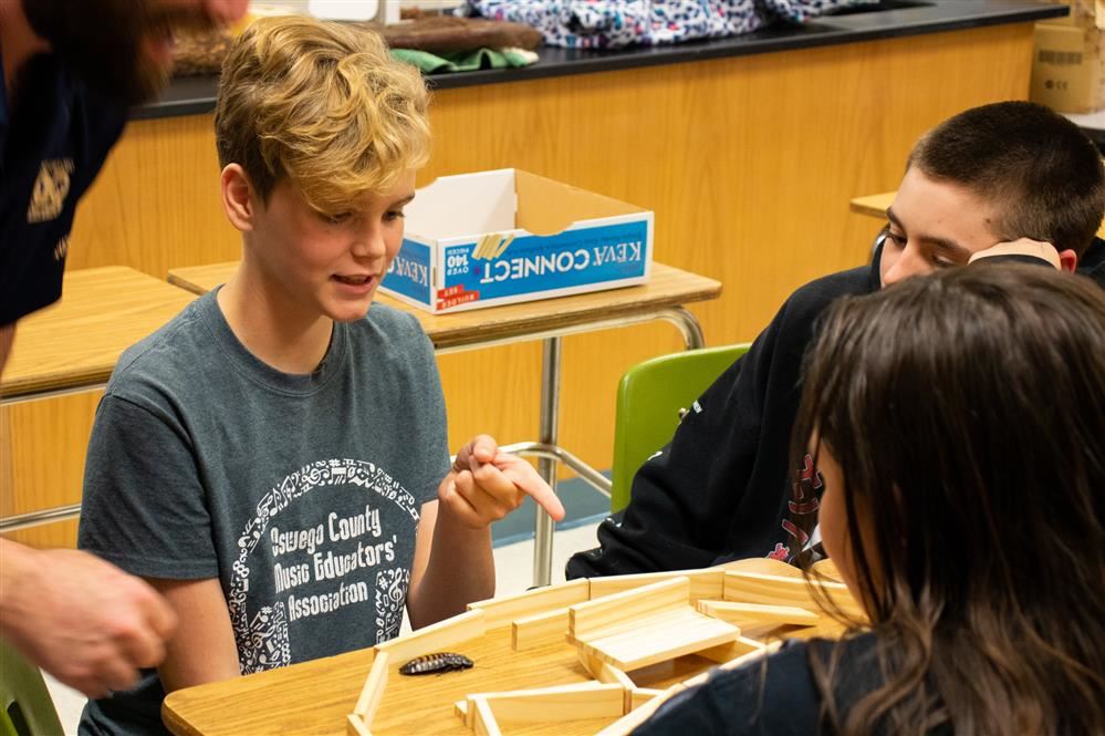  An APW student explains her design for an animal maze